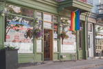 Exterior view of a restaurant in The Village neighbourhood with a pride flag hanging outside