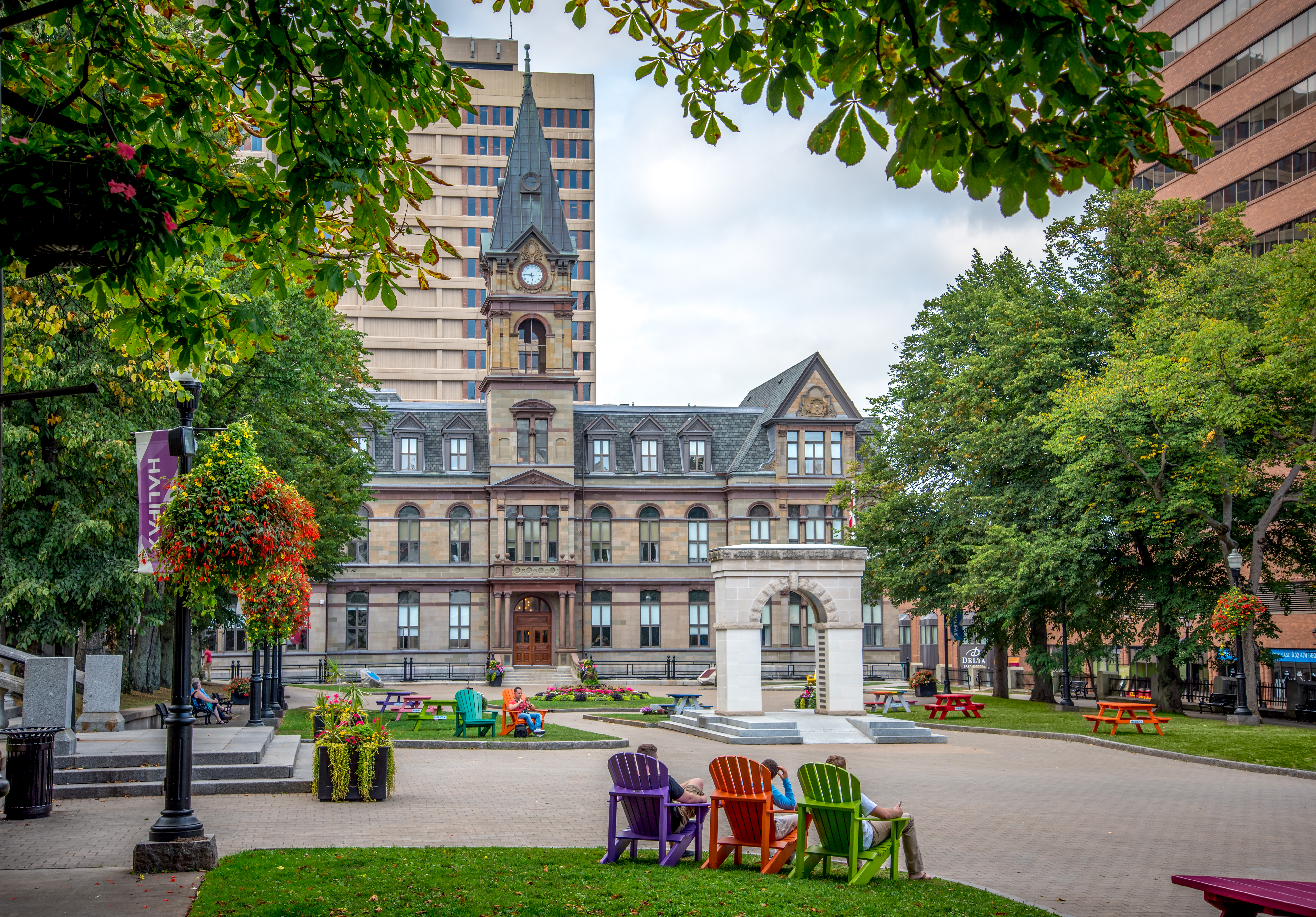 Public square with colourful seats looking towards Victorian-inspired Halifax City Hall