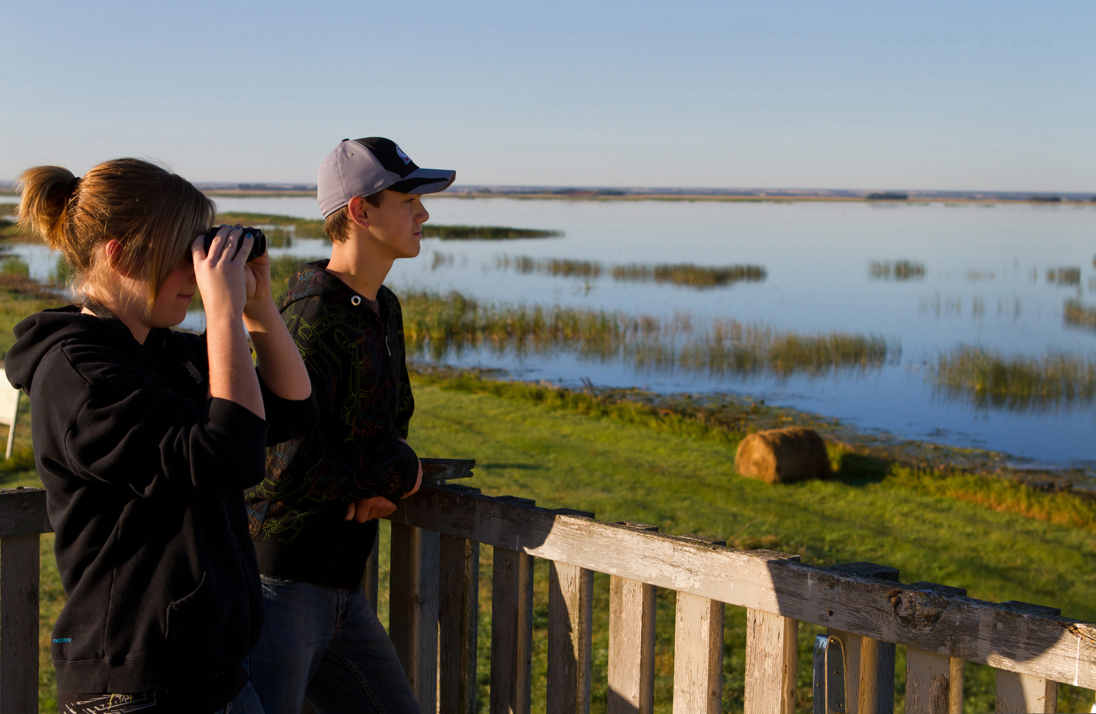Visitors look at saline lake in wildlife viewing site, Quill Lakes International Bird Area, situated near Saskatoon