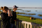 Visitors look at saline lake in wildlife viewing site, Quill Lakes International Bird Area, situated near Saskatoon