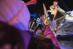 A person using their phone to take photo of Quebec Winter Festival mascot