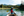 A woman sits in the front of a canoe and paddles across a lake near Quesnel 