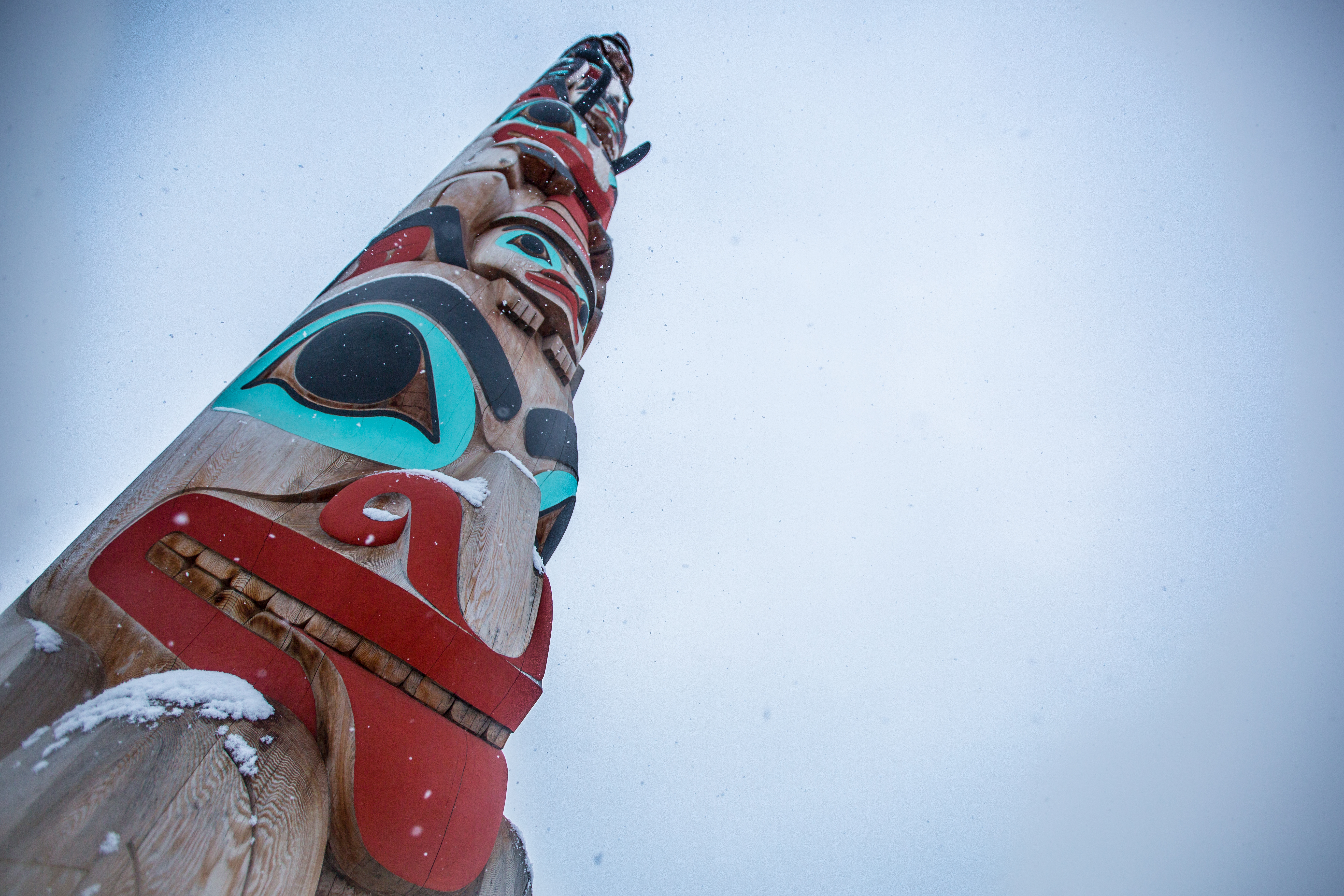 Close up of Two Brothers Totem Pole as snow falls in Jasper