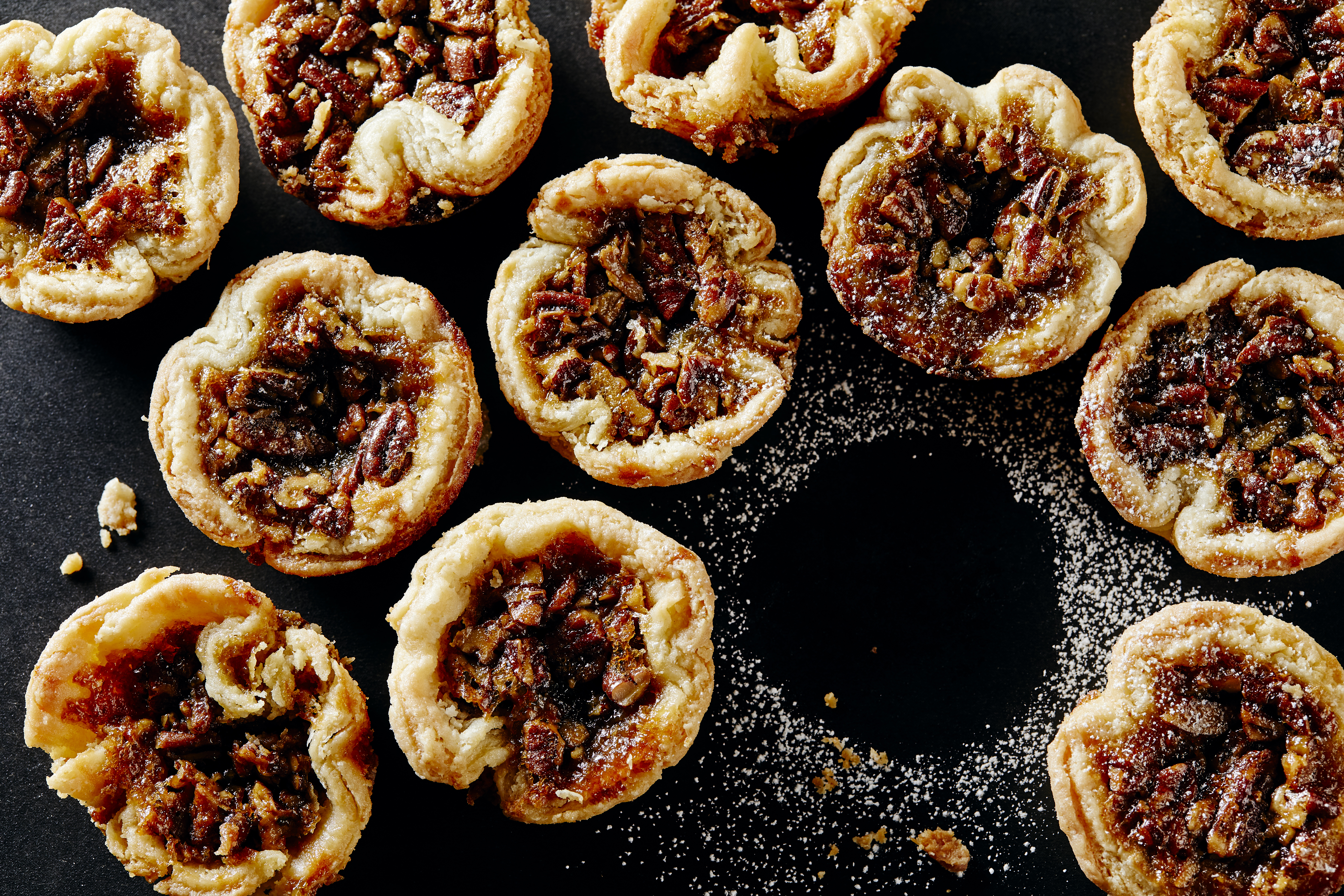 A close-up shot of classic Canadian maple Butter Tarts with pecans as toppings