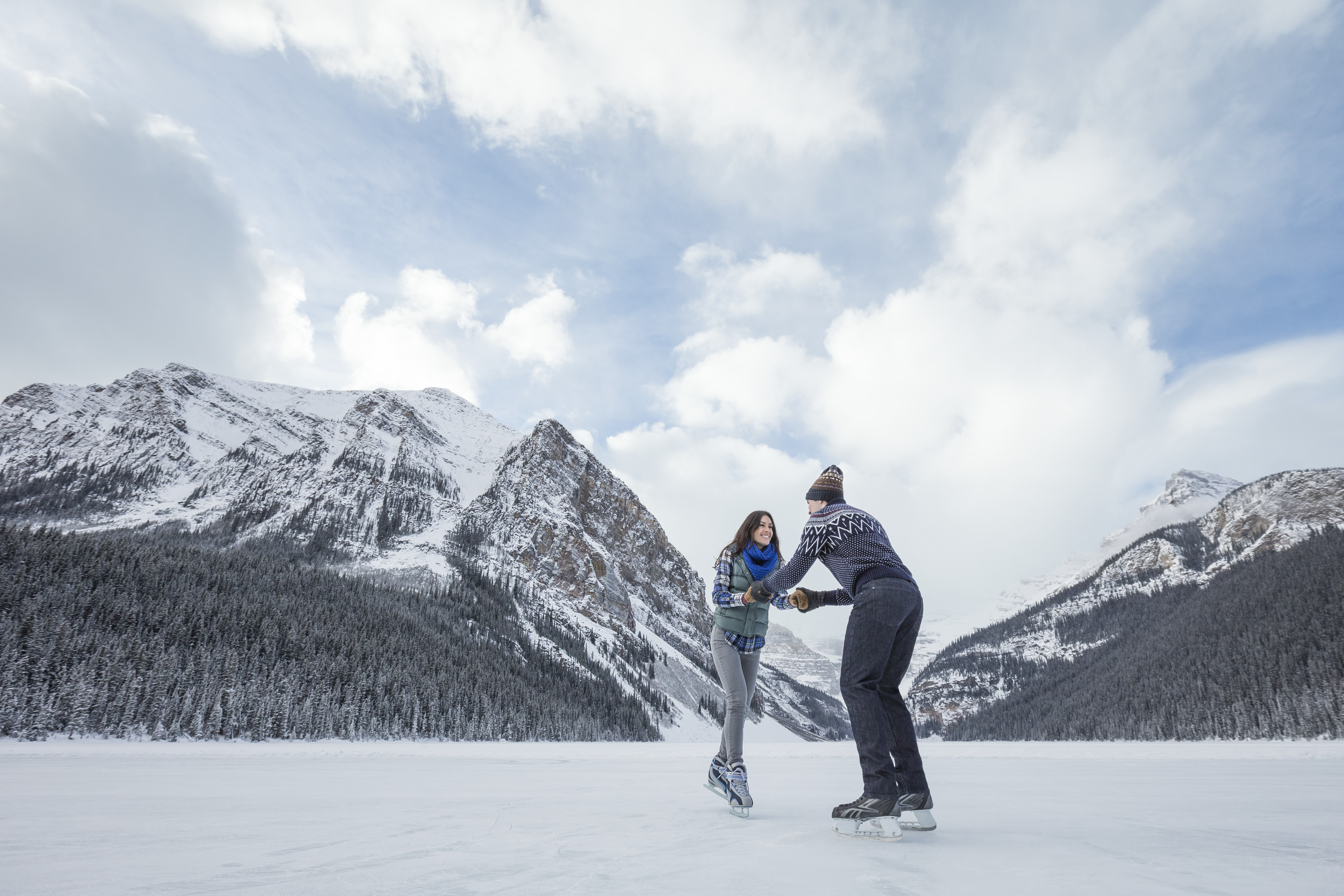 Couple skating in frozen Lake in banff
