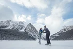 Couple skating in frozen Lake in banff