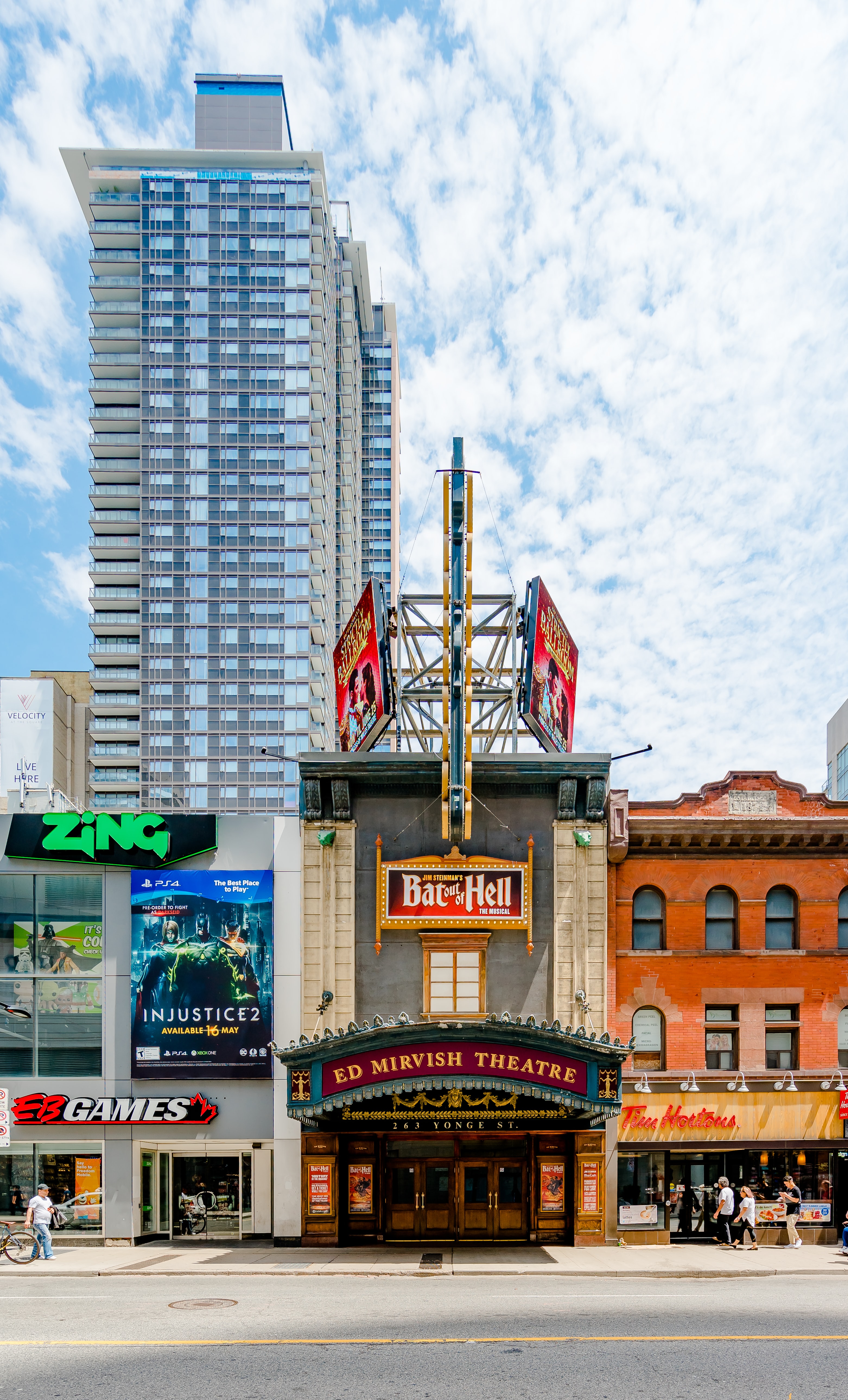 A view of vibrant commercial street with brick building and classic theatre entrance