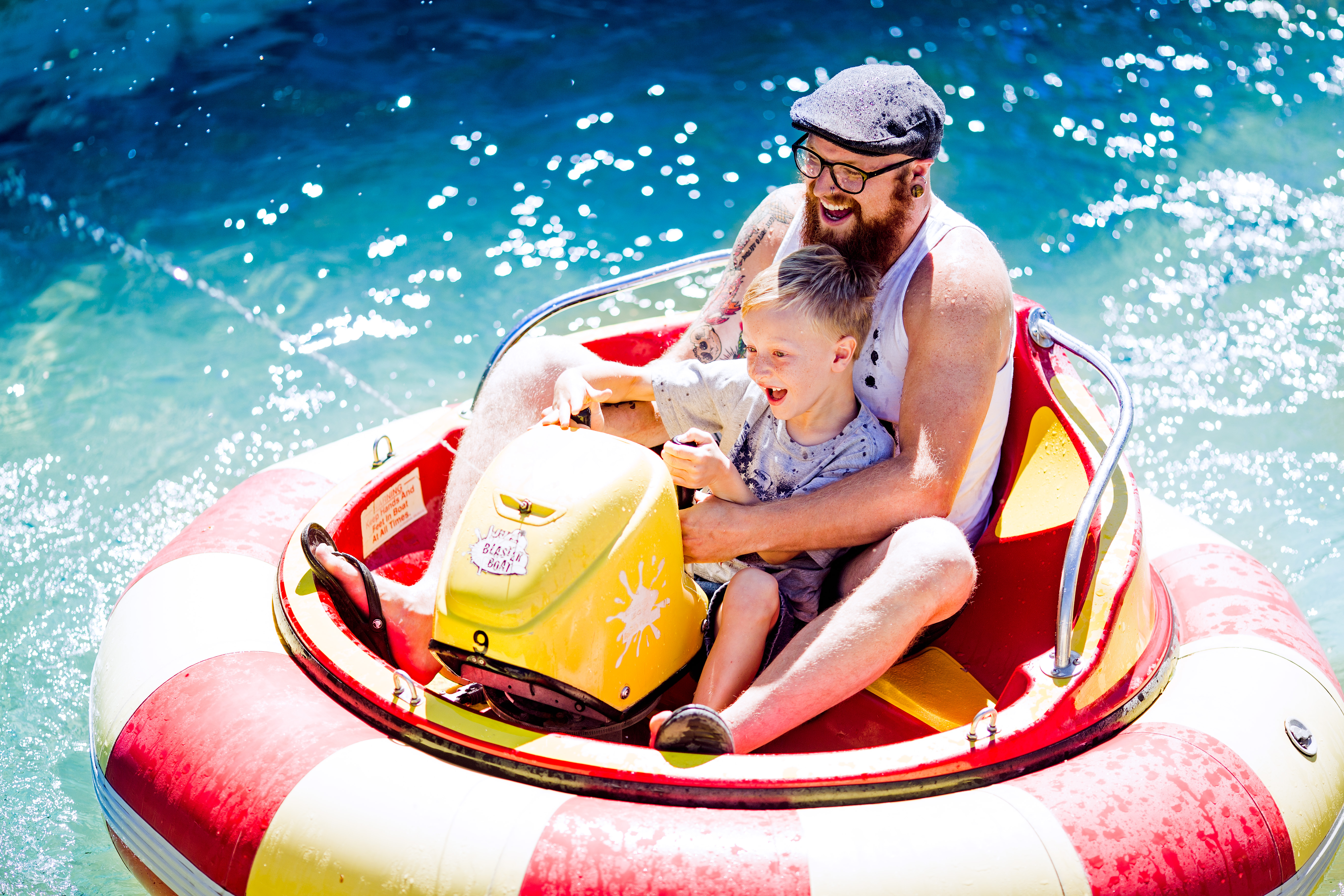 Father and son sitting on a bumper boat 