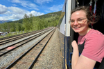 Person looking at camera, standing in the outdoor area on Rocky Mountaineer train