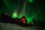 Multicoloured northern lights form in sky over Inn on the Lake 