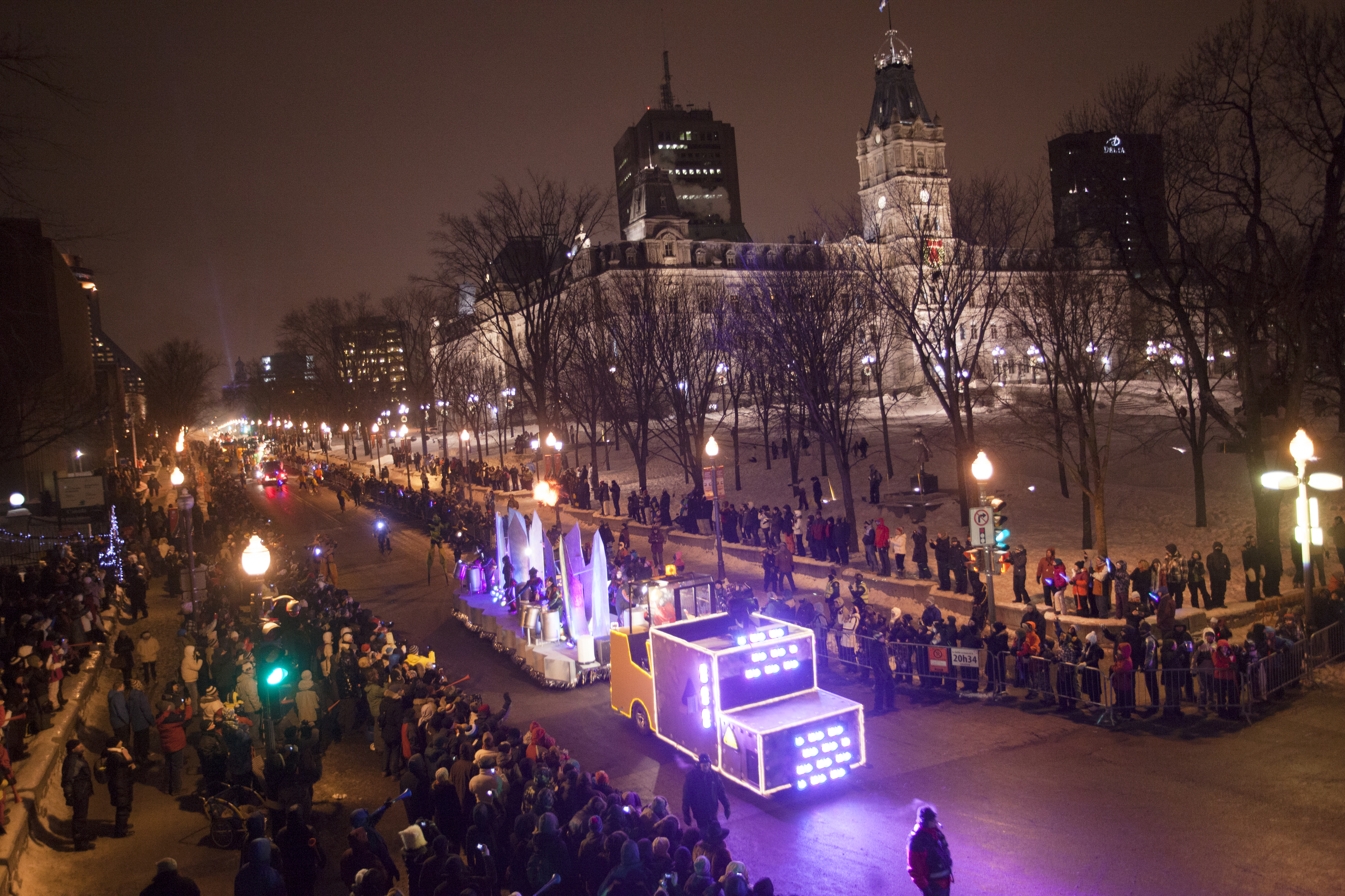 Crowd of people watching the night parade in the Quebec Winter Carnival