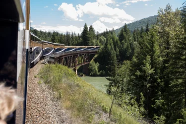 Rocky Mountaineer travelling over a bridge on the Journey Through the Clouds route