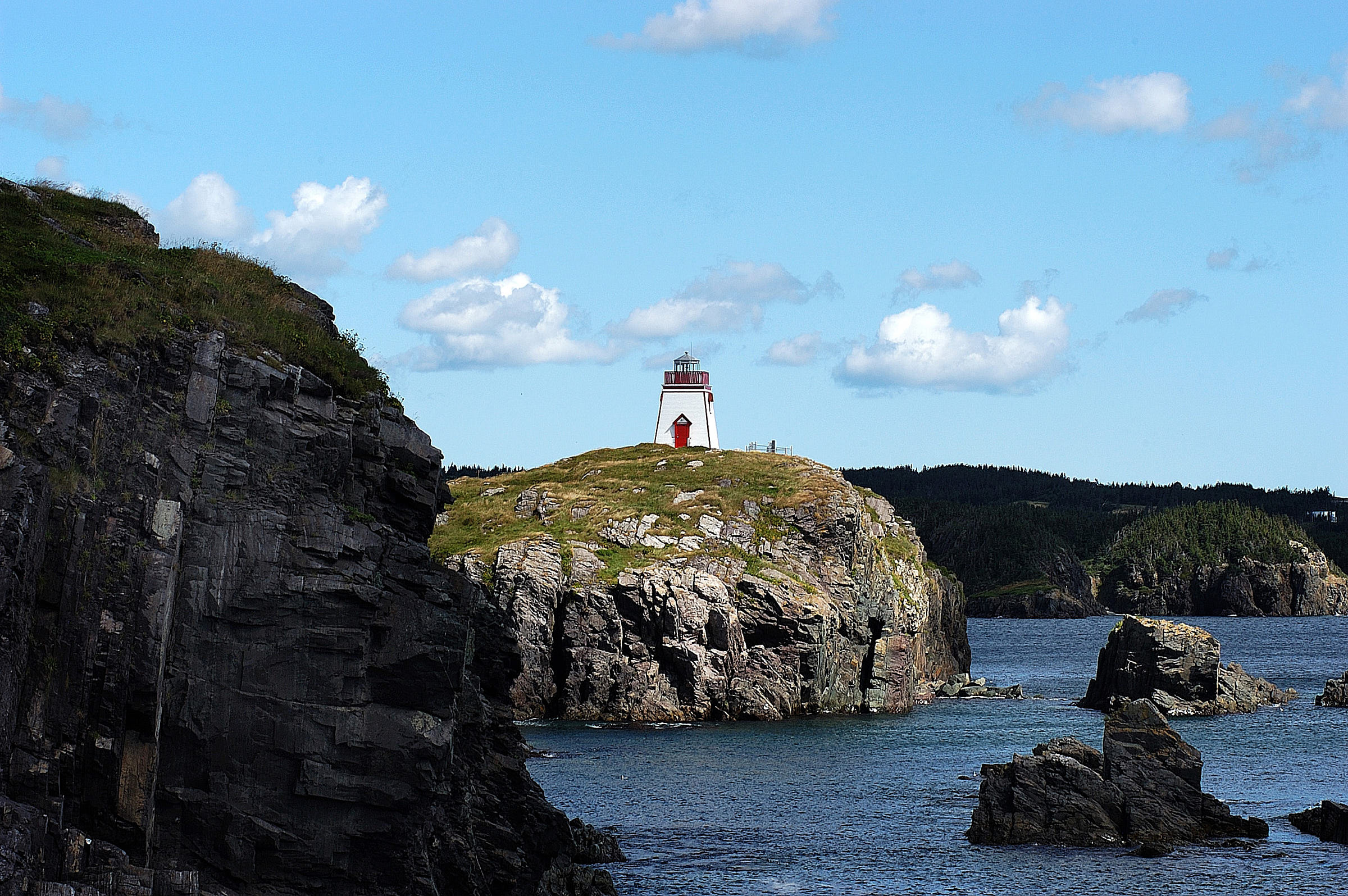 A lighthouse and rocky coastline near Trinity Eastern