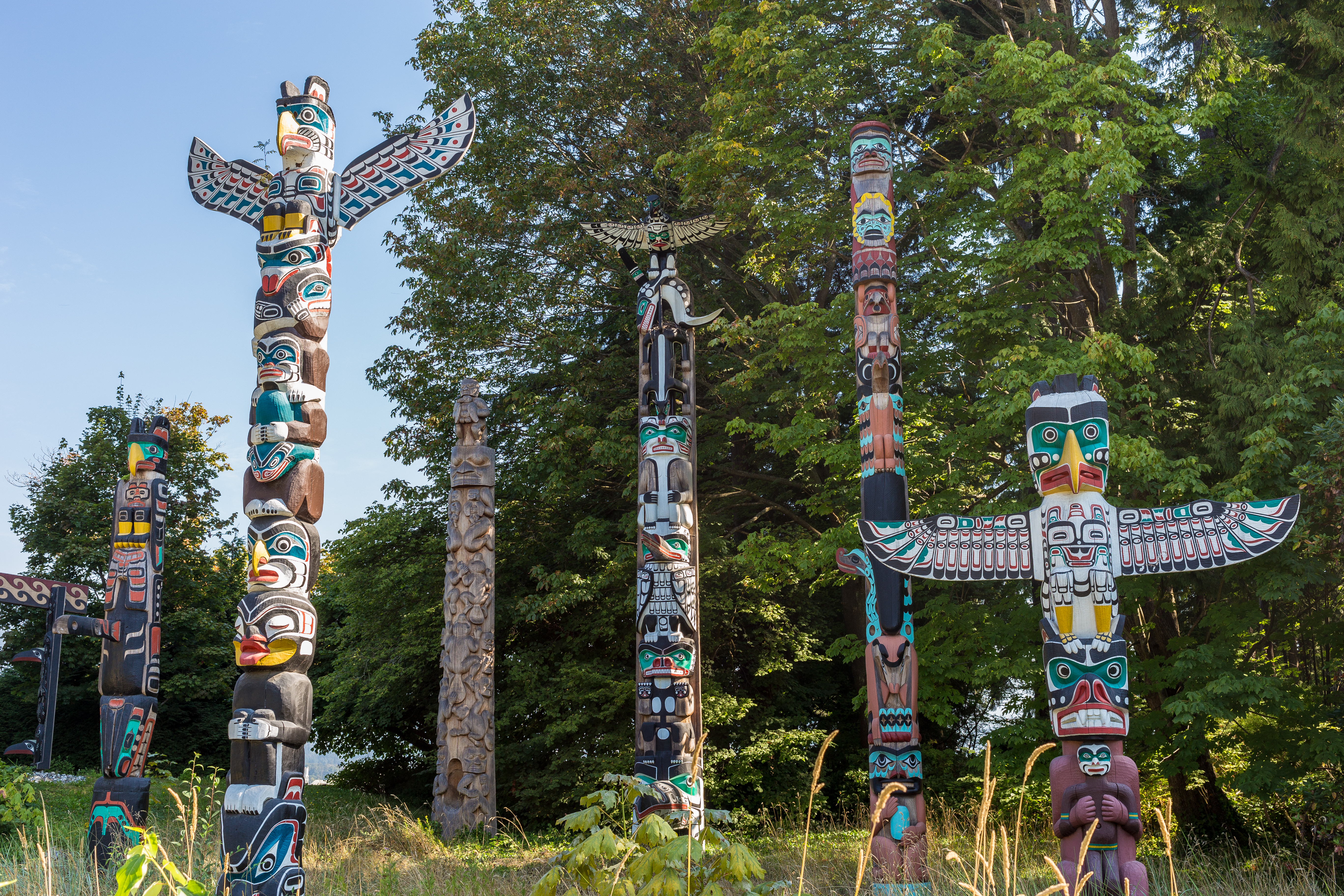 Six colourful totem poles in Stanley Park, Vancouver
