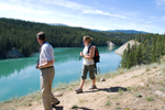 Visitors look at turquoise river in Yukon near Whitehorse