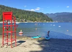 people swim at deep cove beach in summer, red lifeguard chair