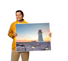 A person holding a large sign board with Canadian scenery on it
