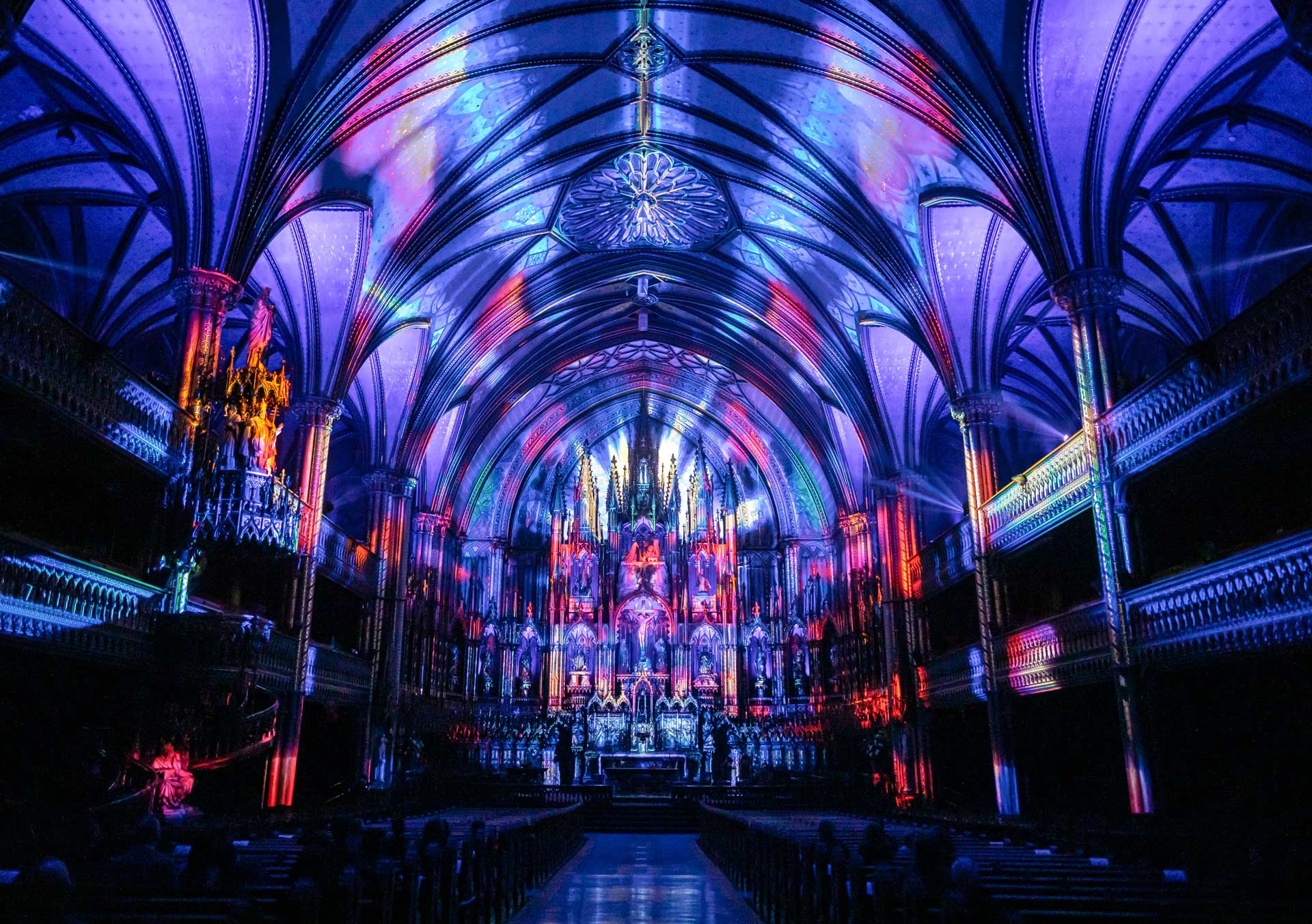 Interior of the Notre-Dame Basilica lit up in bright colours for AURA