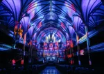 Interior of the Notre-Dame Basilica lit up in bright colours for AURA