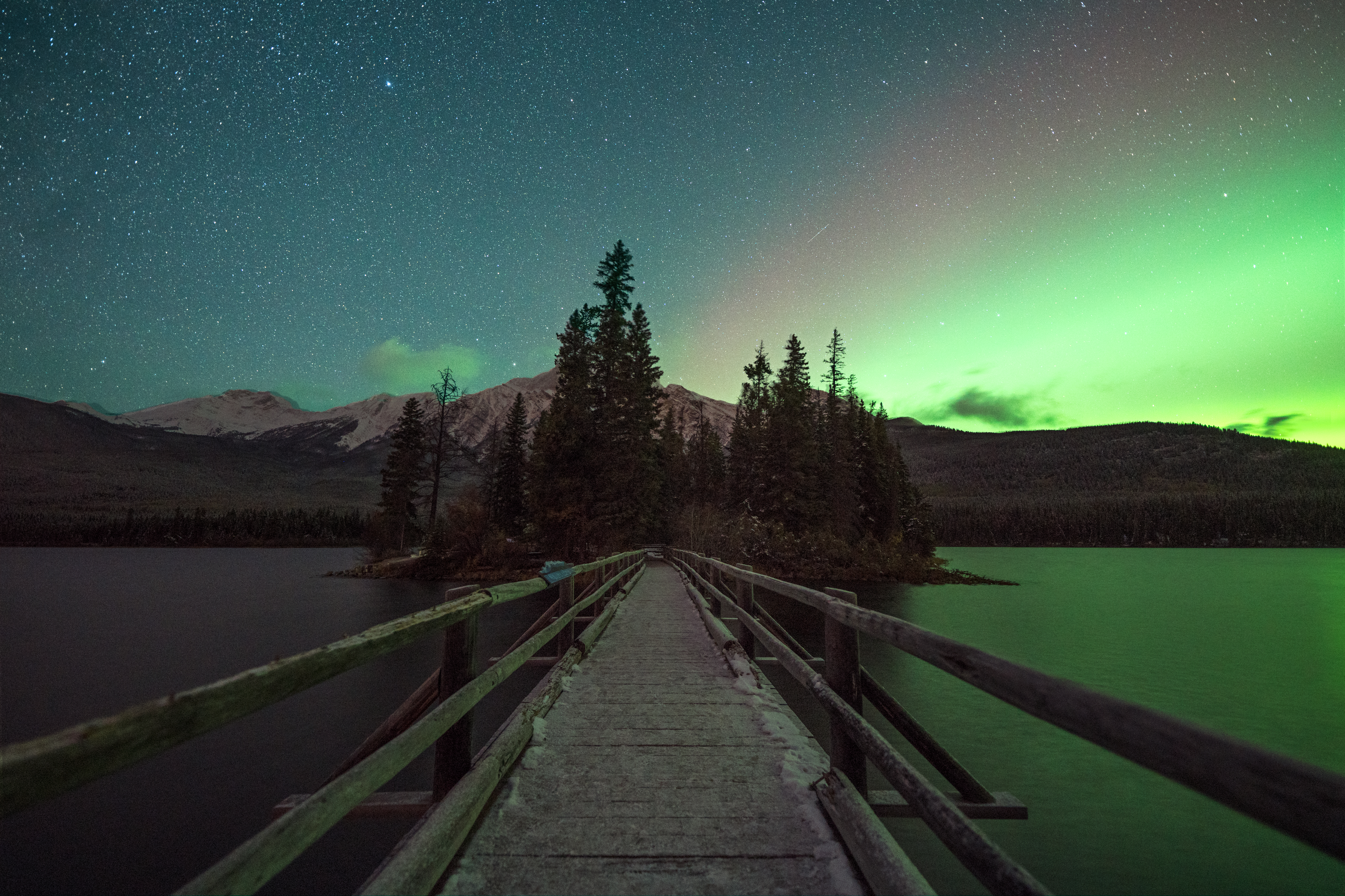 Aurora in starry sky above Pyramid Lake in Jasper National Park