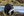 A black bear with a fish on the rocky coastline of Port Hardy