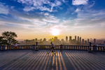 Man biking along the lookout at Mount Royal Park at sunset