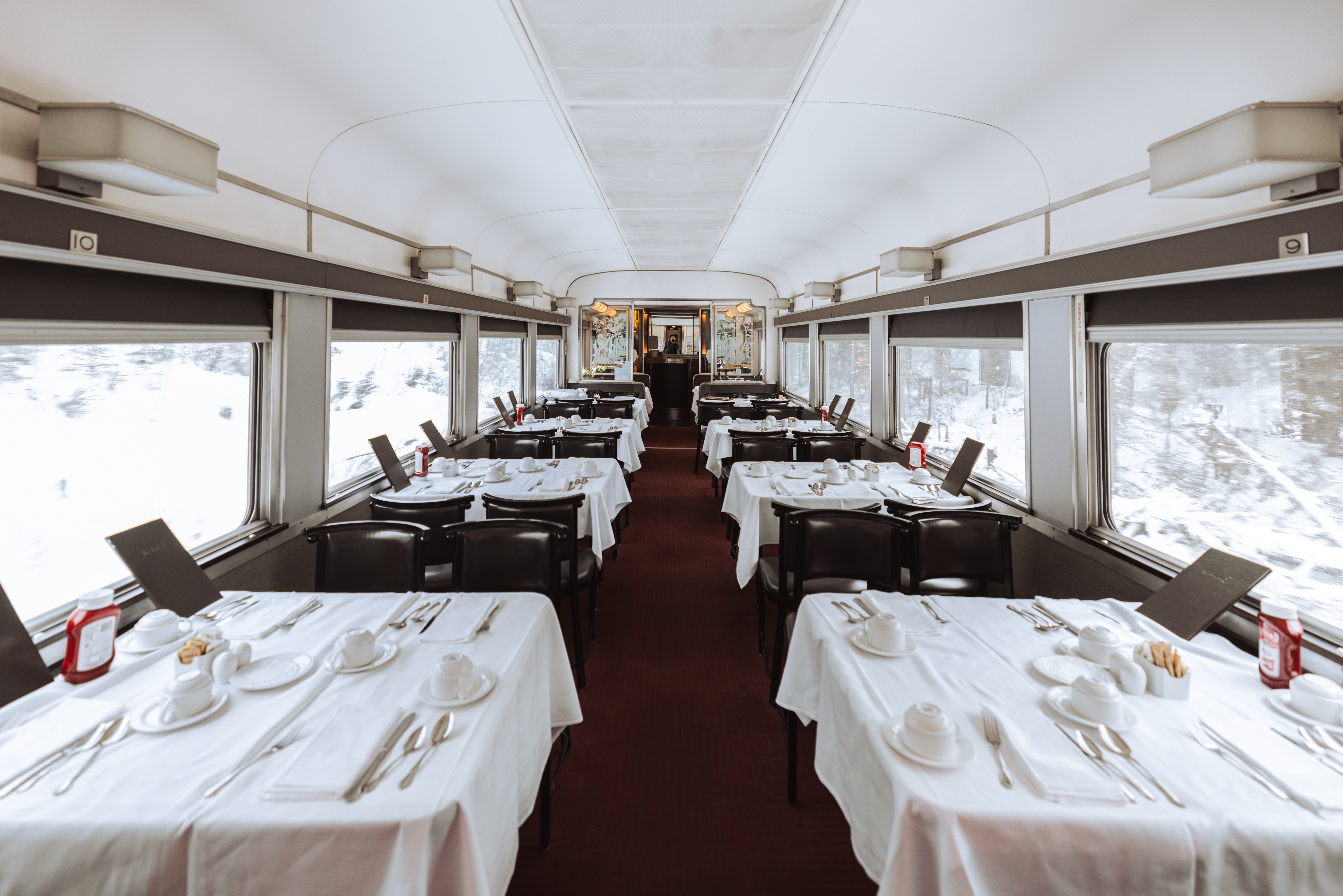 Vacant Dining car with set tables onboard VIA Rail's train, the Canadian
