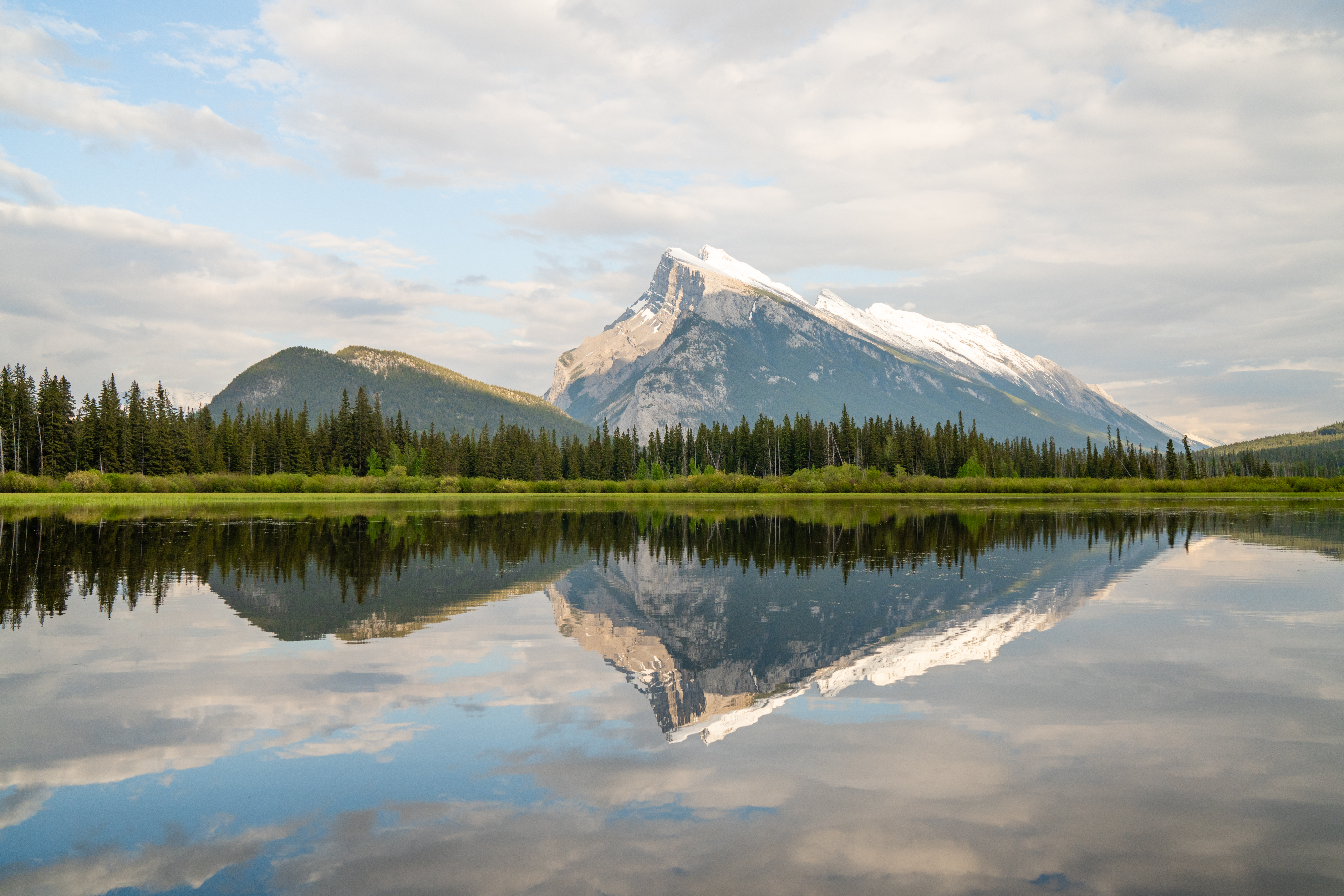 Vermilion Lakes' clear waters reflect Mount Rundle in the Bow Valley region