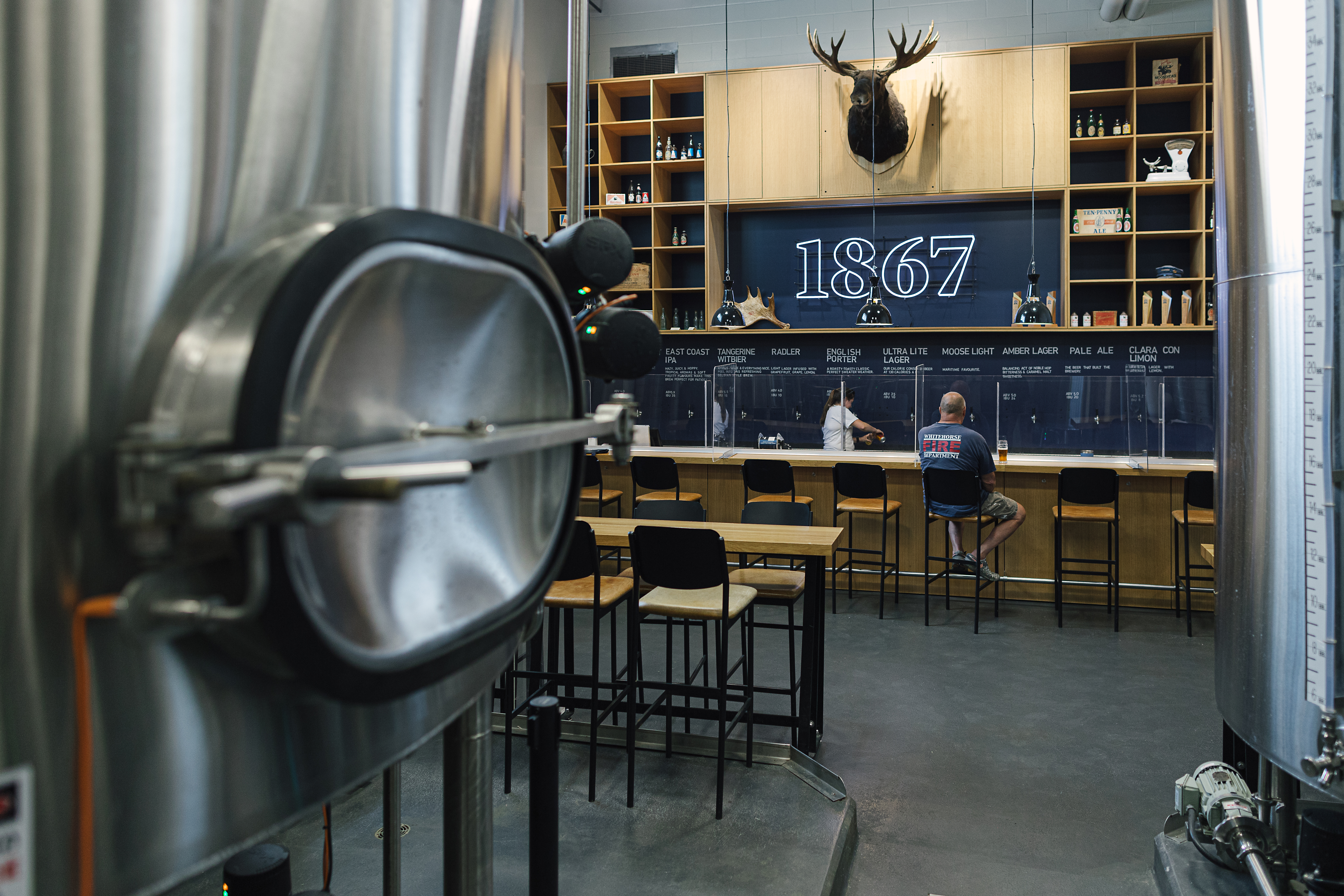 Brewery with bar and vessel on display nearby