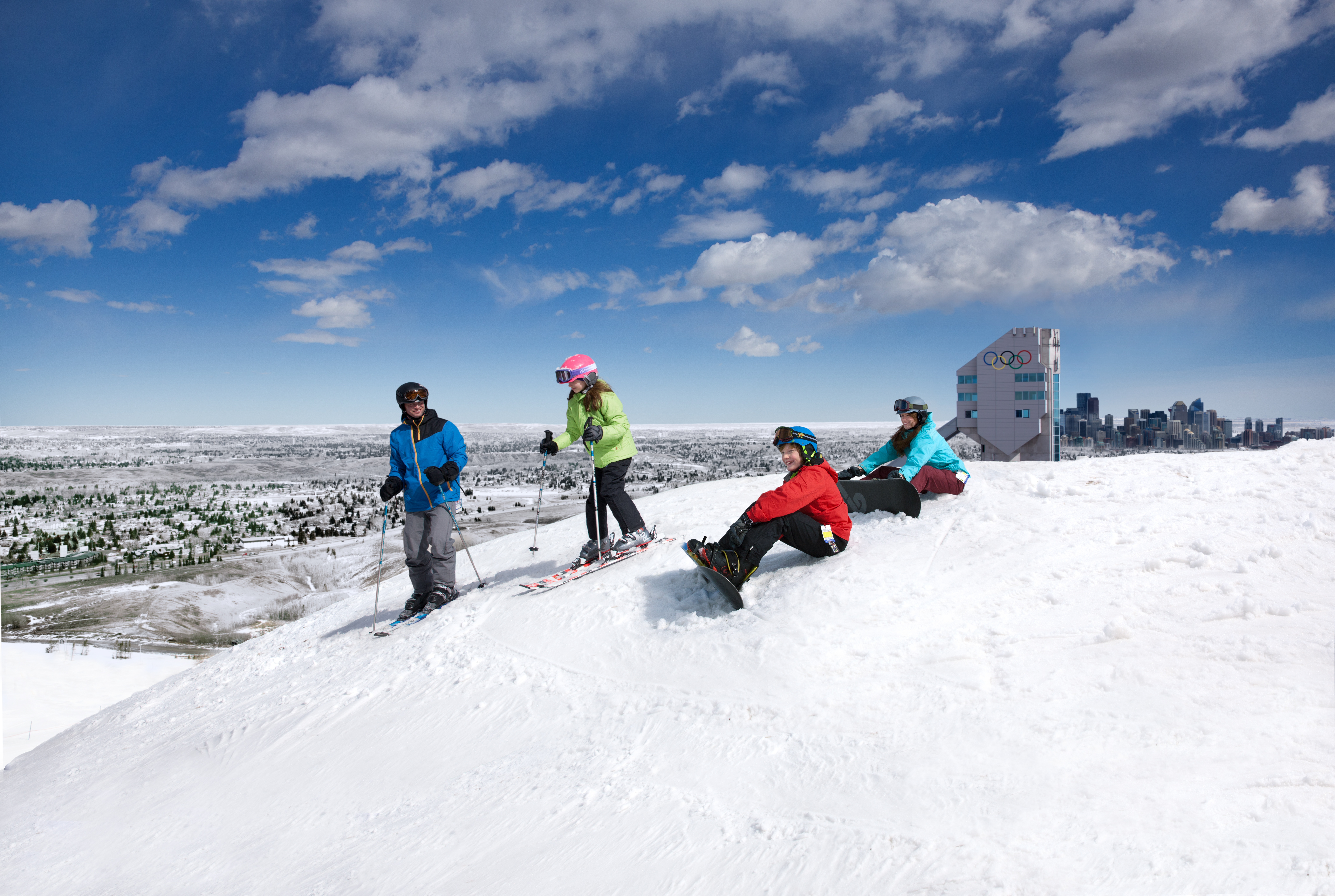 Group of skiers and snowboarders at the top of a ski hill in Winsport Canada Olympic Park