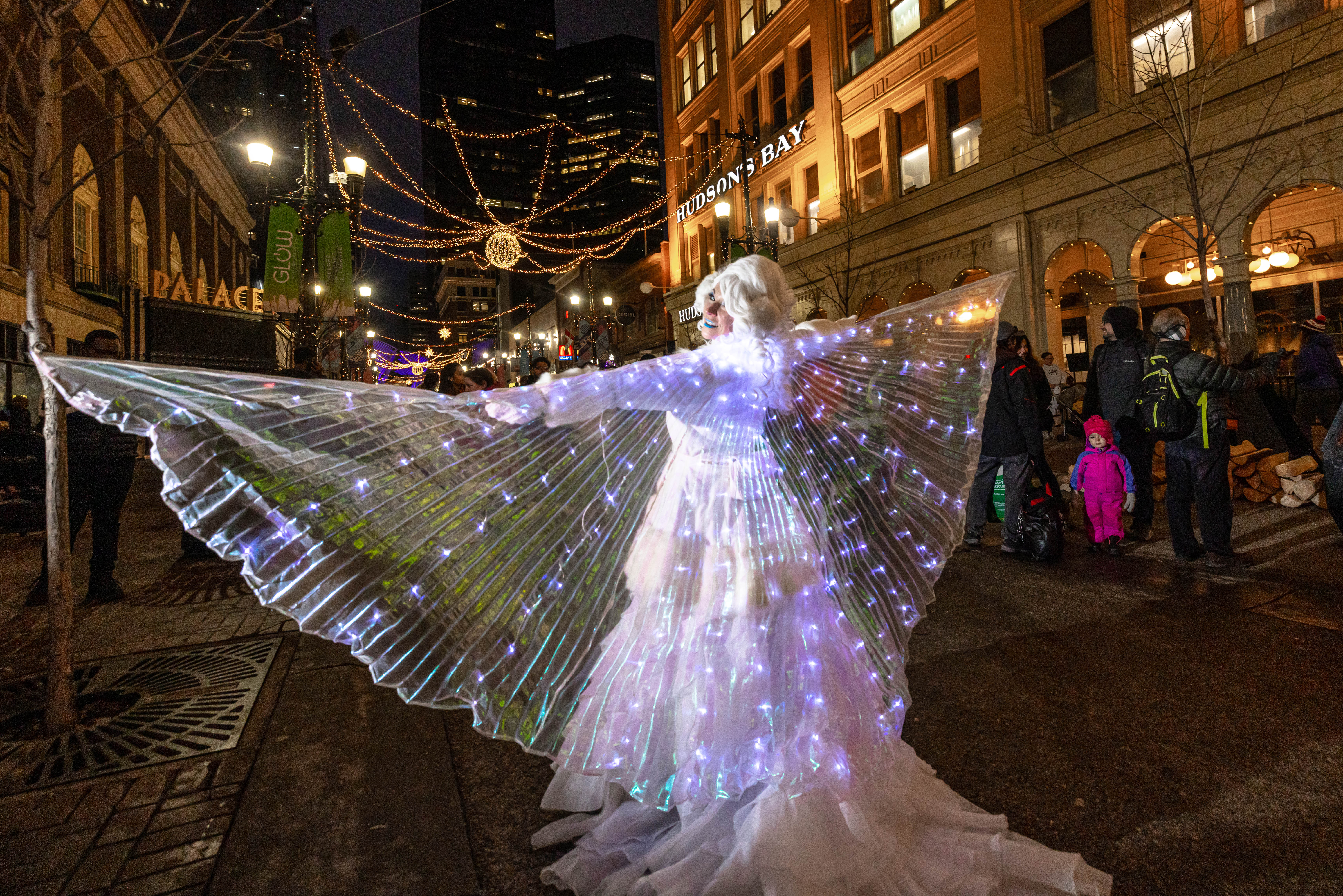 A street performer with large light up wings at the Chinook Blast winter festival 