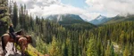 Horseback rider with a view of mountains and trees in Banff