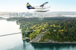 Float plane flies over water in Burrard Inlet and above Stanley Park during daytime