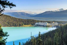 blue Lake Louise with trees and Fairmont Hotel in background