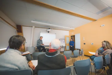 People listening to a presenter giving a talk at the Churchill Northern Studies Centre