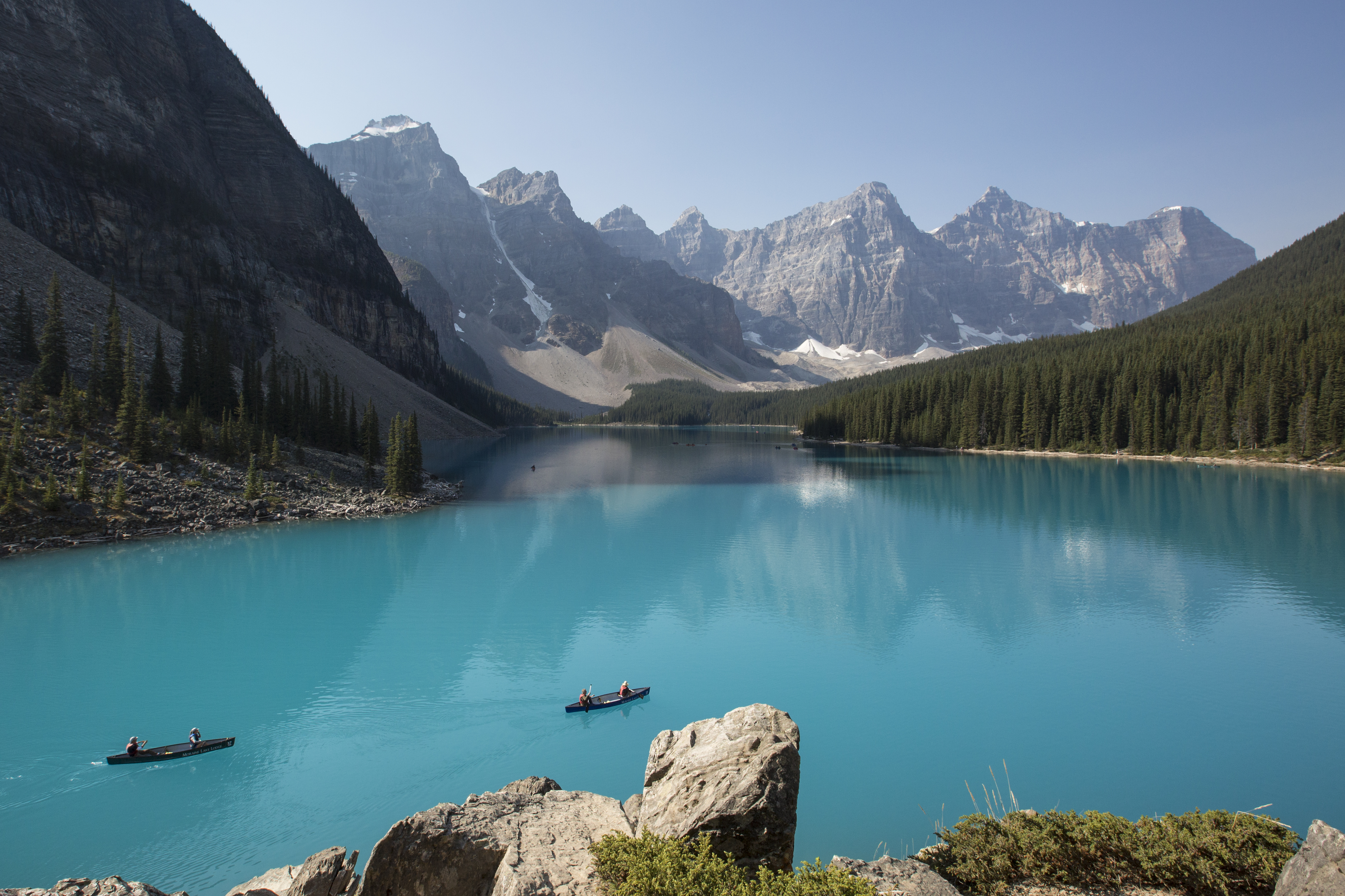 Two canoes cruise the Azure waters of Moraine Lake