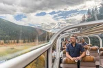  Man looking out window of Rocky Mountaineer train
