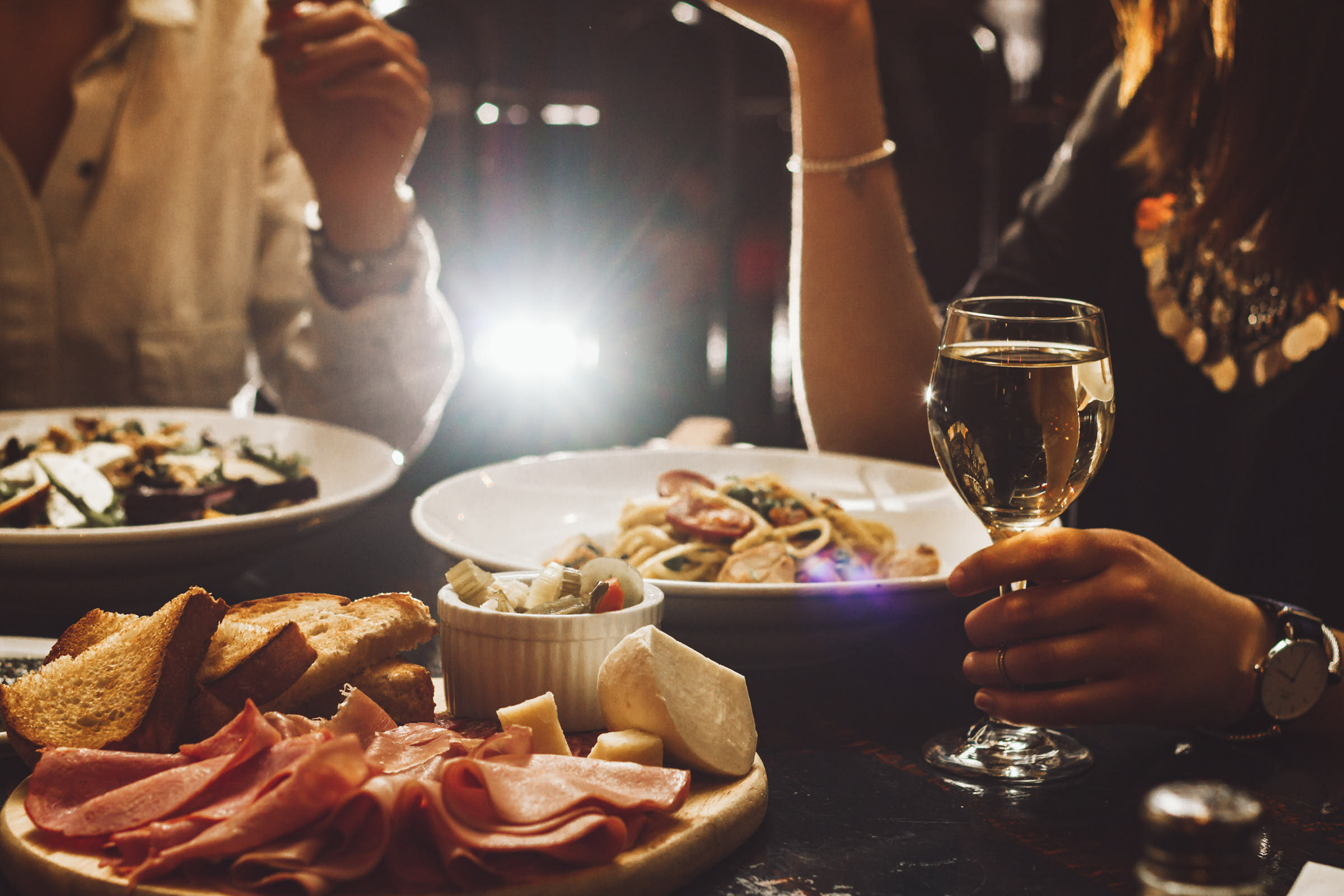 Couple eating and drinking wine at a restaurant