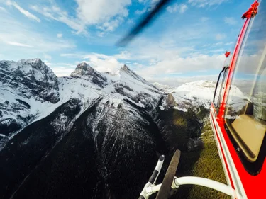 Helicopter flying over snowcapped mountains