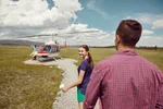 Couple approaching their helicopter before their tour with Alpine Helicopters