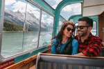 couple enjoy the mountain scenery from Maligne Lake boat cruise