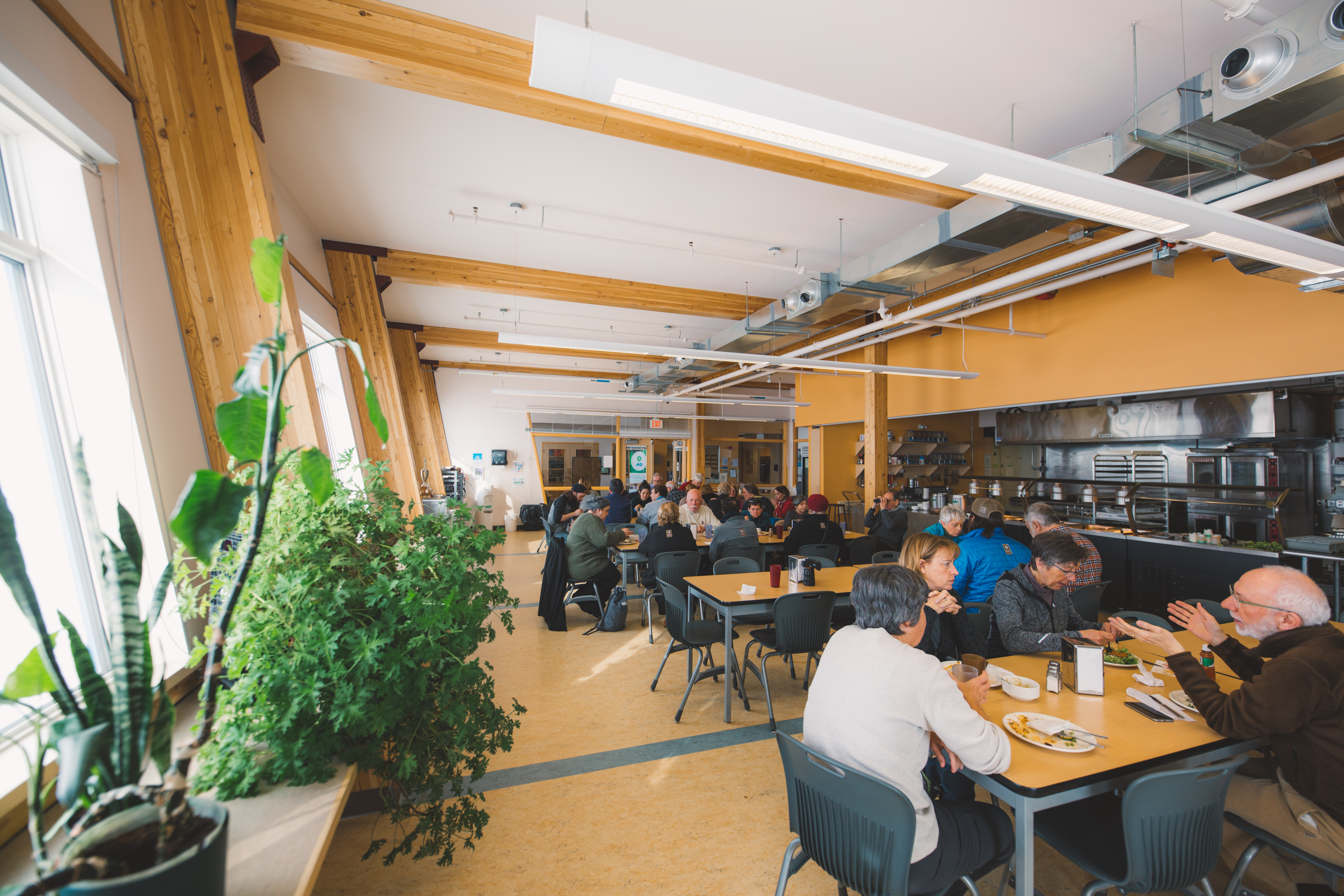 People sitting and enjoying a meal in the cafeteria of the Churchill Northern Studies Centre