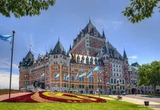 Chateau Frontenac historic hotel, castle architecture, with gardens out front
