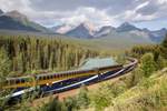 Train winds through Morant’s Curve riding along Bow River with the Canadian Rockies in the background