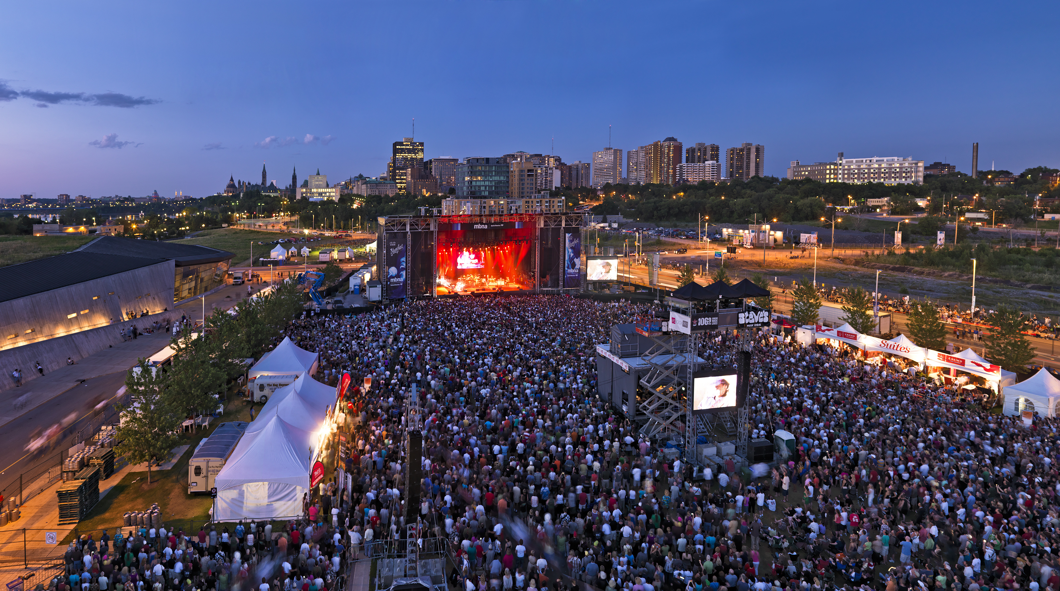 Aerial view of a large crowd watching an outdoor music show at Ottawa Blues Festival
