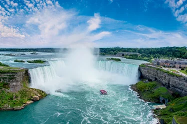 A birds eye view of a Hornblower Cruise boat approaching the Niagara Falls