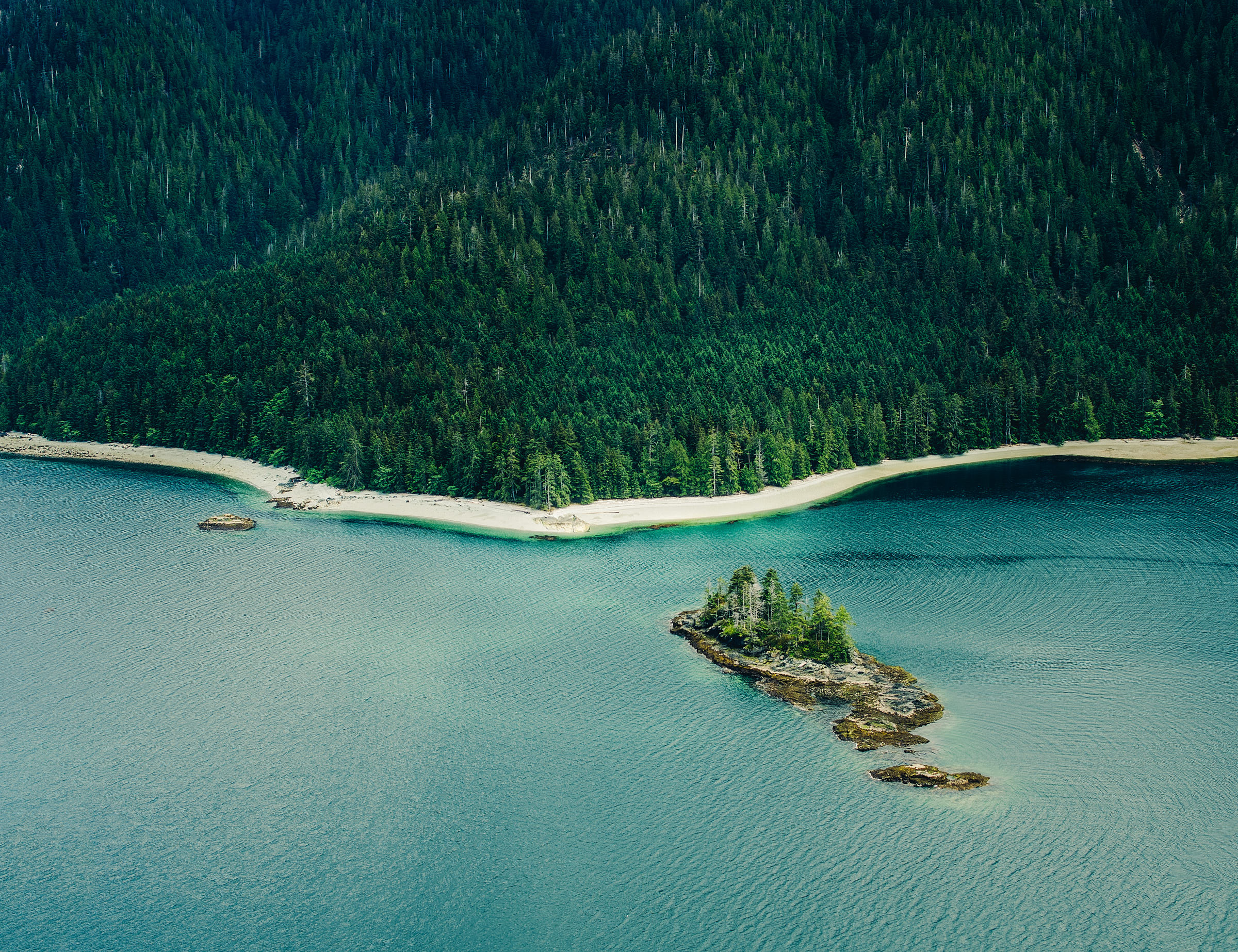 Turquoise waters hug coast of remote tropical archipelago in Northern British Columbia