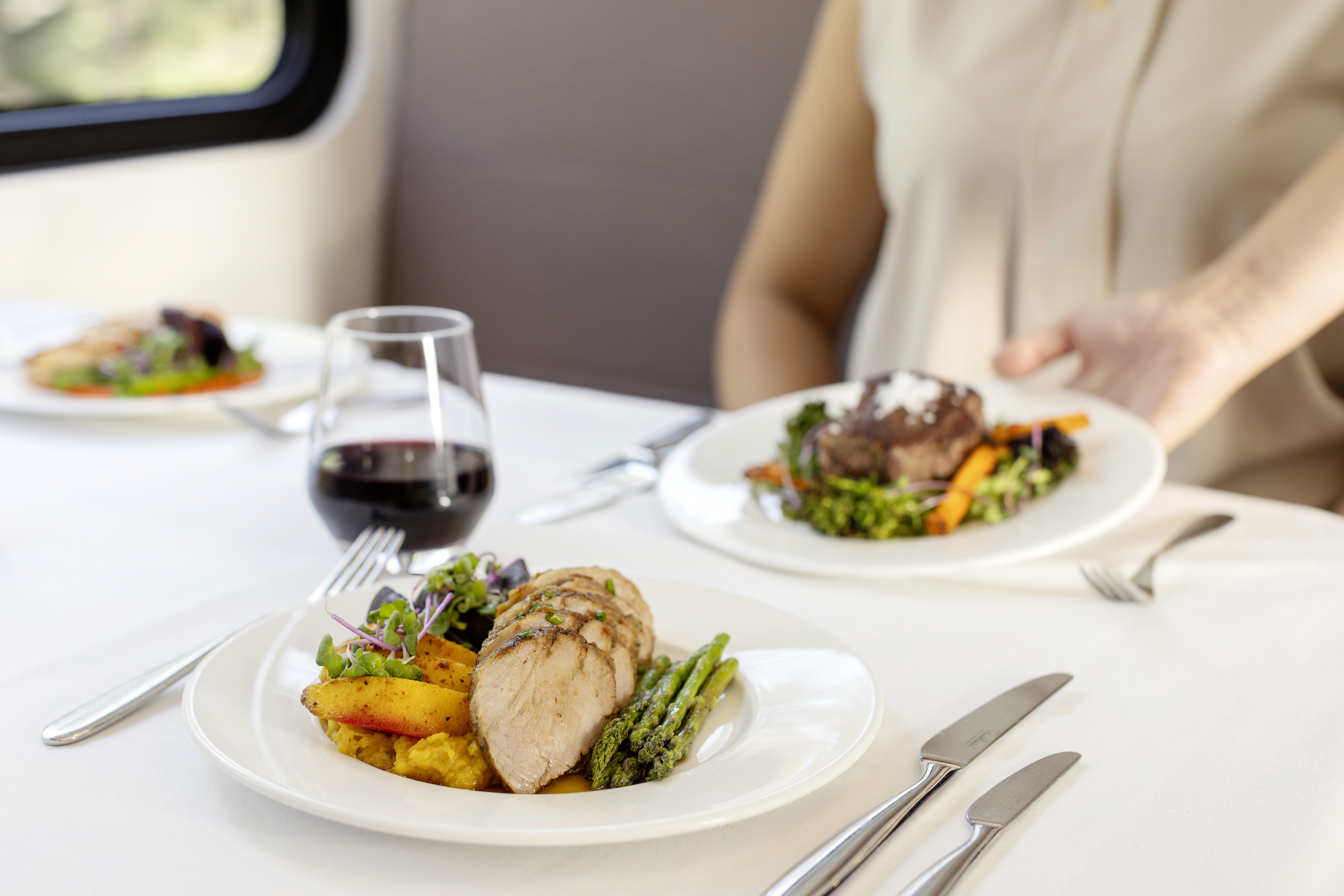 Close up of plates of Chicken palliard on a GoldLeaf dining table