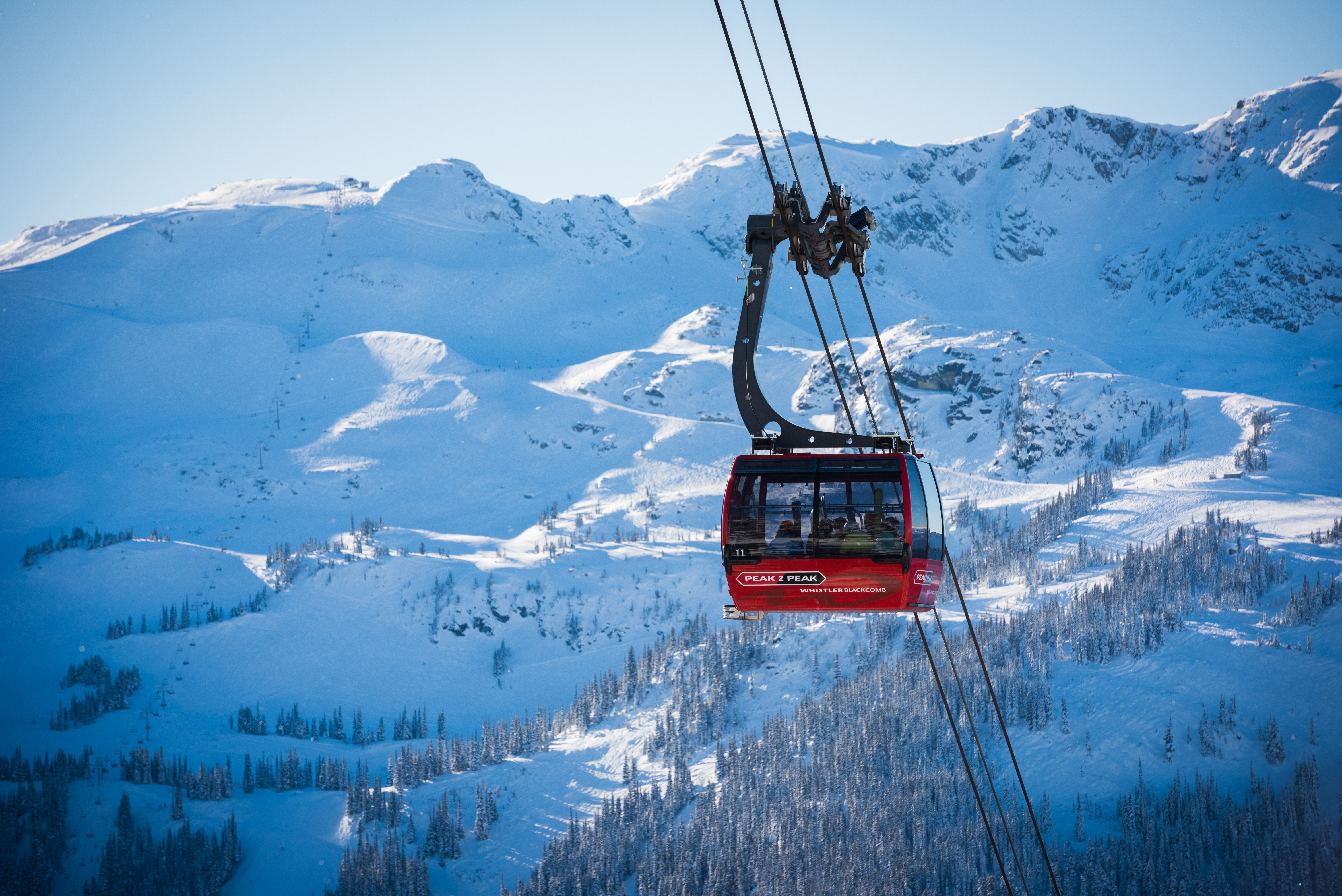 Whisterl Peak 2 Peak Gondola with a snowy mountain behind