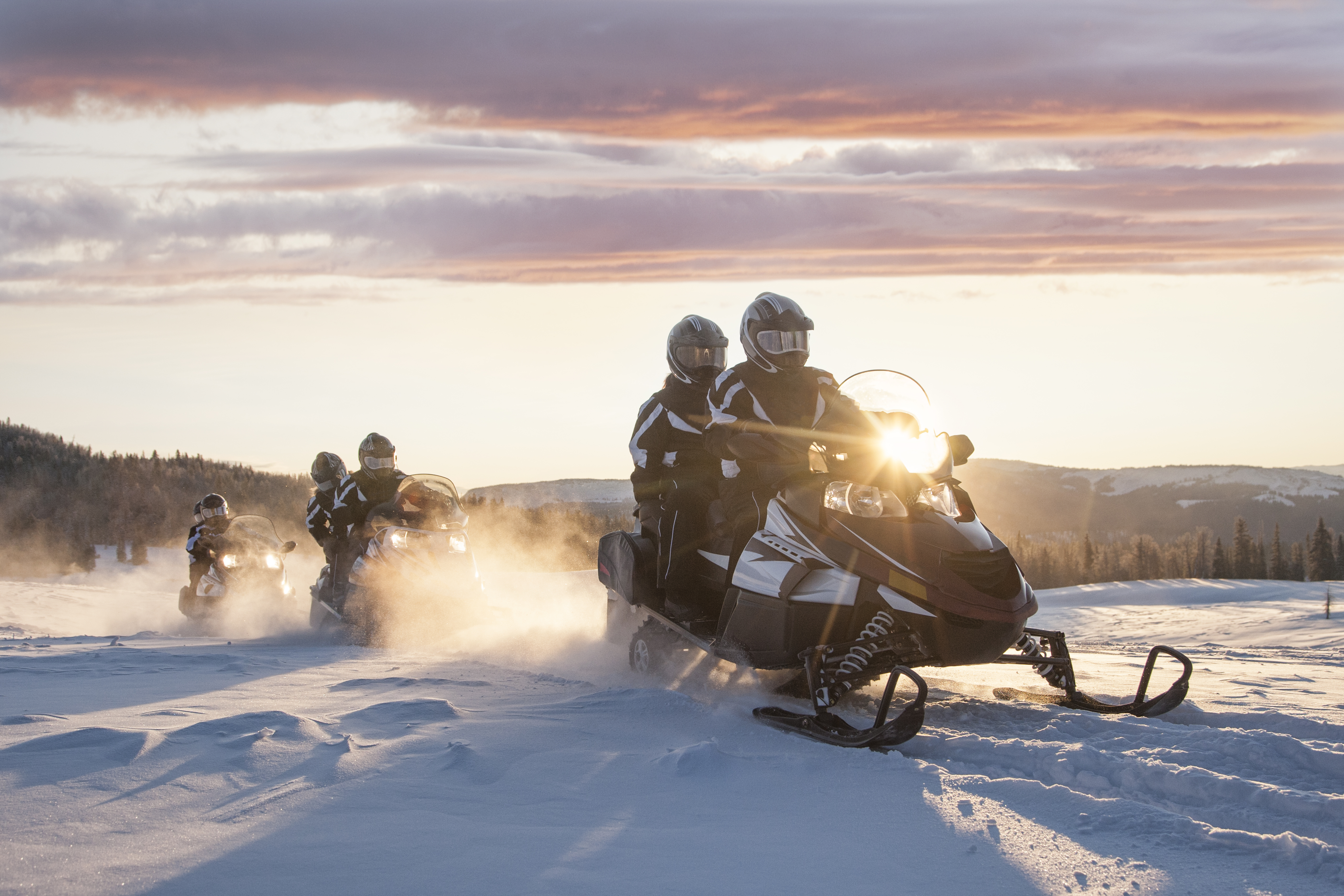 Sunrise snowmobile touring in the mountains